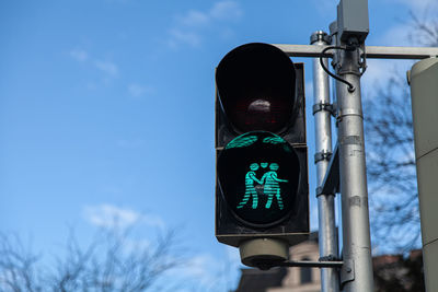 Low angle view of road signal against blue sky