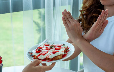 Midsection of woman holding ice cream