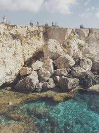 Rocks in sea against sky