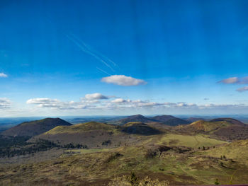 Scenic view of mountains against blue sky