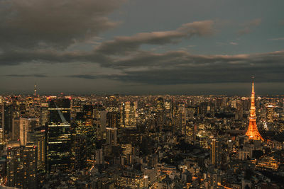 Illuminated cityscape against sky at night