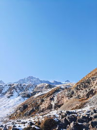 Scenic view of snowcapped mountains against clear blue sky