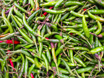 Full frame shot of green chili peppers for sale at market