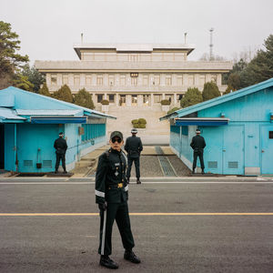 People walking on street amidst buildings in city