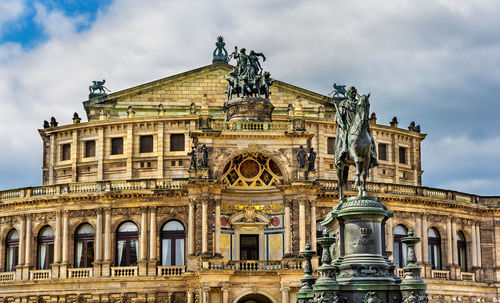 Low angle view of historical building against cloudy sky