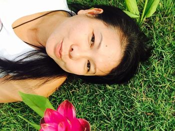 Close-up portrait of boy lying on grass