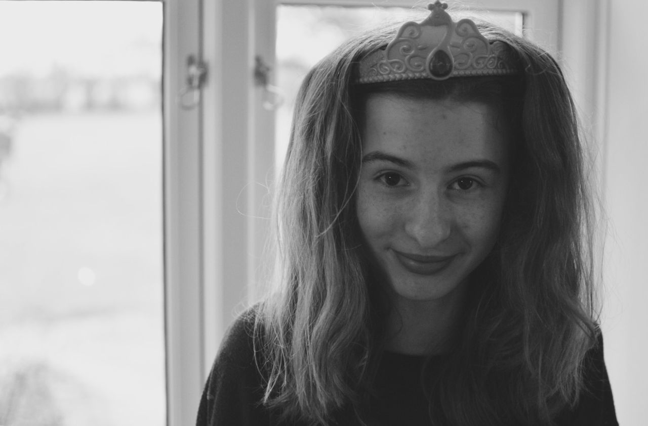 headshot, focus on foreground, lifestyles, long hair, young adult, person, indoors, leisure activity, young women, close-up, head and shoulders, brown hair, window, front view, human face, contemplation, portrait