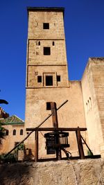 Low angle view of historic building against clear blue sky