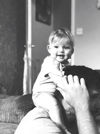 Portrait of baby girl playing with father at home