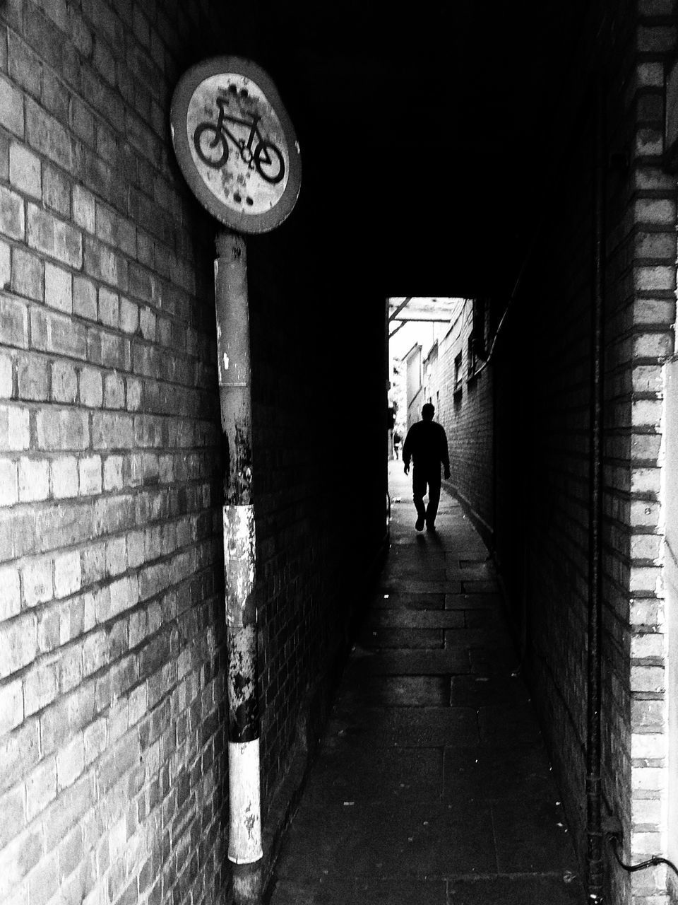 REAR VIEW OF PEOPLE WALKING ON ALLEY