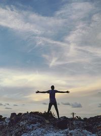Rear view of man standing on rocks