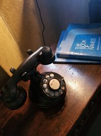 Close-up of old telephone on table