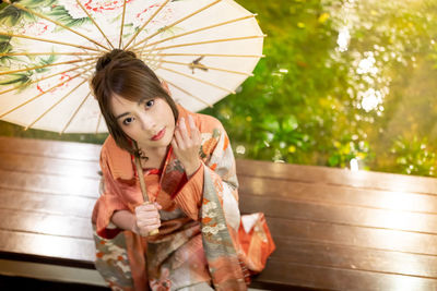 Portrait of beautiful woman wearing traditional clothing sitting outdoors