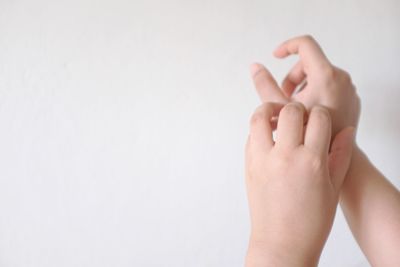 Close-up of human hand over white background