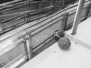 High angle view of balls by railing 