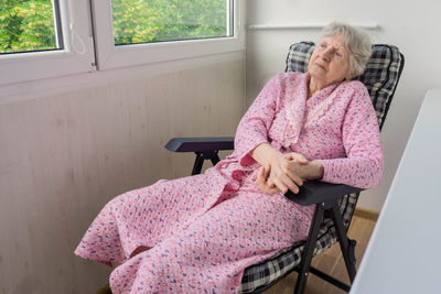 Woman sitting on chair at home