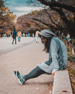 Full length of woman sitting in park