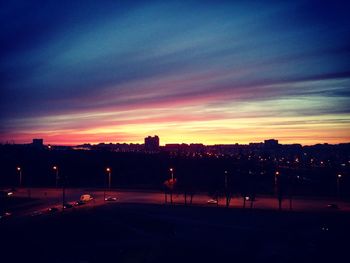 Silhouette city against sky at sunset