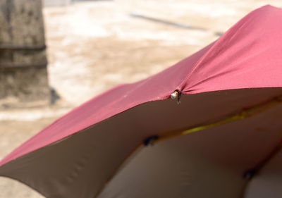 Close up uv umbrella in summer sun. umbrella blocking the sunlight. sunbath tanning shade shadow.