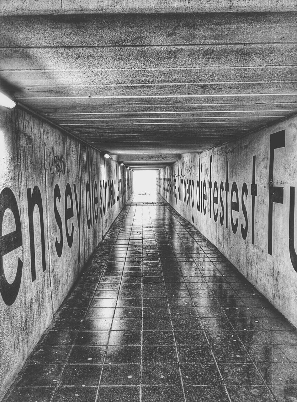 text, western script, graffiti, the way forward, communication, built structure, architecture, wall - building feature, indoors, diminishing perspective, capital letter, empty, tunnel, wall, non-western script, information sign, vanishing point, ceiling, no people, information