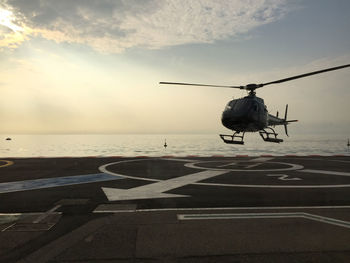 Rear view of person on sea against sky during sunset