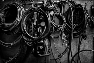 Close-up of tangled cables on wall