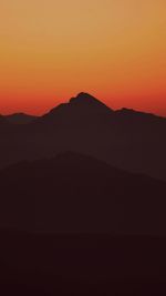 Scenic view of silhouette mountains against sky during sunset