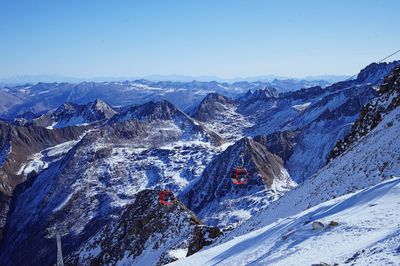 High angle view of snowcapped mountains against blue sky