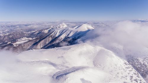 High angle view of snowcapped mountains against sky