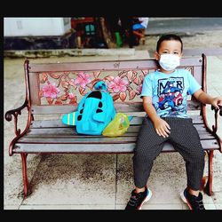 Portrait of boy sitting on seat