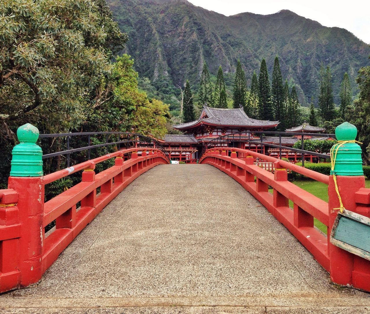 mountain, built structure, tree, architecture, connection, bridge - man made structure, transportation, travel destinations, railing, travel, tourism, mountain range, famous place, water, red, high angle view, tranquility, river, scenics, nature