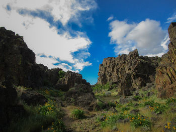 Rock formations on landscape against sky