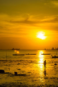 View of the beach with some boats during sunset in bangkalan, madura, indonesia