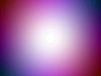 Sun shining over pink sky