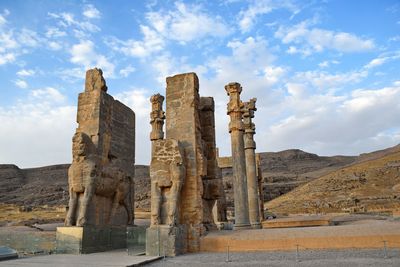 Gate of all nations against cloudy sky