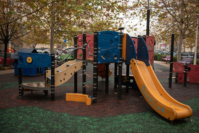 View of playground against trees in park