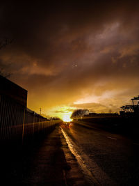 Road against dramatic sky during sunset