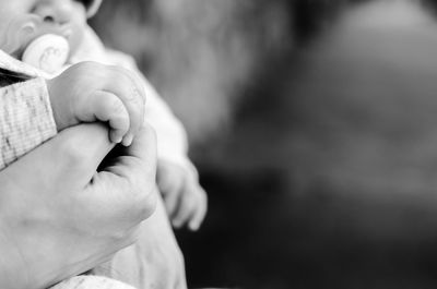 Close-up of hands holding baby hand