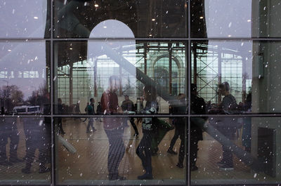Reflection of people on glass window