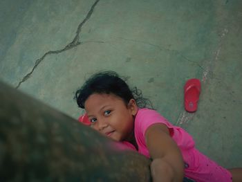 Portrait of smiling girl against wall