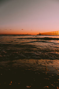 Scenic view of sea against romantic sky at sunset