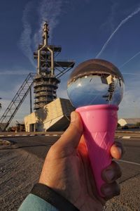 Cropped hand of women holding glasball 