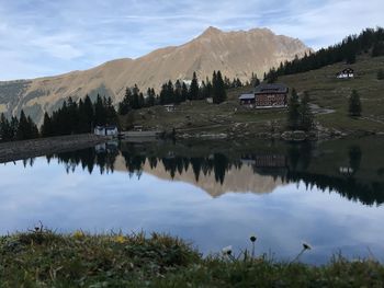 Scenic view of lake and mountains against sky