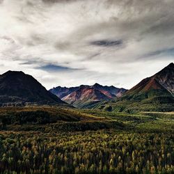 Scenic view of mountains against cloudy sky