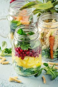 Close-up of fruits in glass jar on table