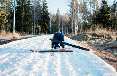 Man skiing on snow covered land