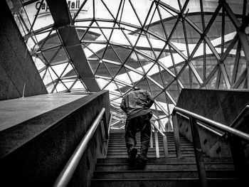 Low angle view of woman walking on staircase