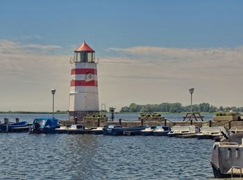 Boats in sea with buildings in background