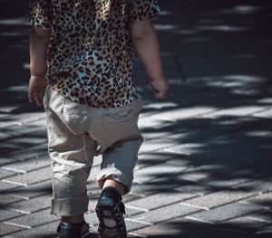 Low section of woman standing on street