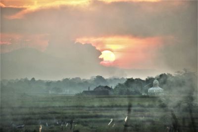 Scenic view of field against sky during sunset